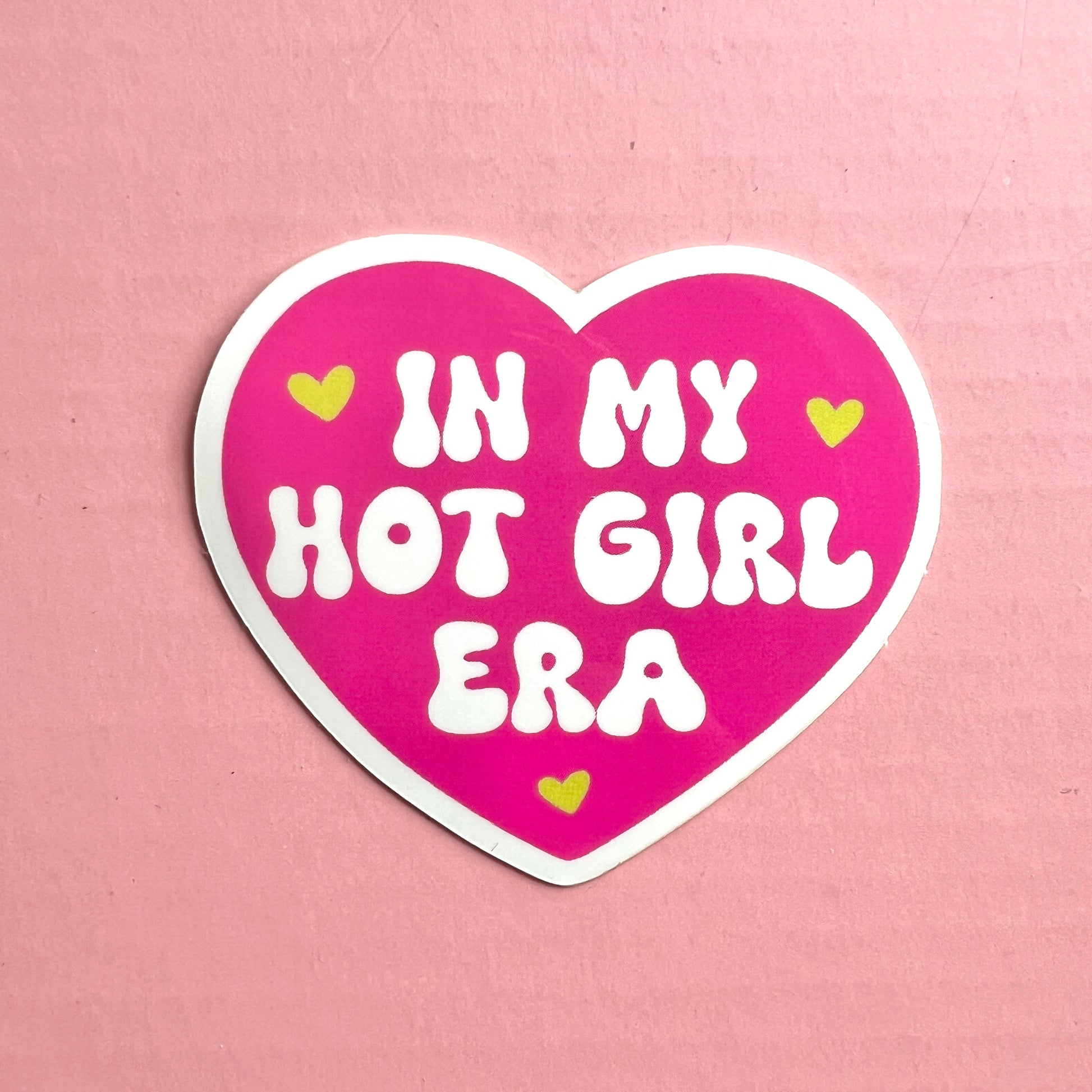 pink heart vinyl sticker with the phrase "in my hot girl era" with three smaller green hearts