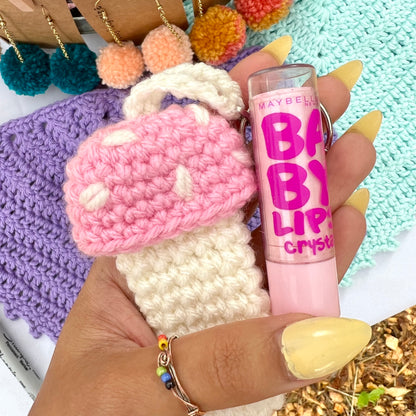 pink and white crochet mushroom keychain that can hold chapstick