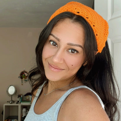 girl wearing an orange crochet hair bandana