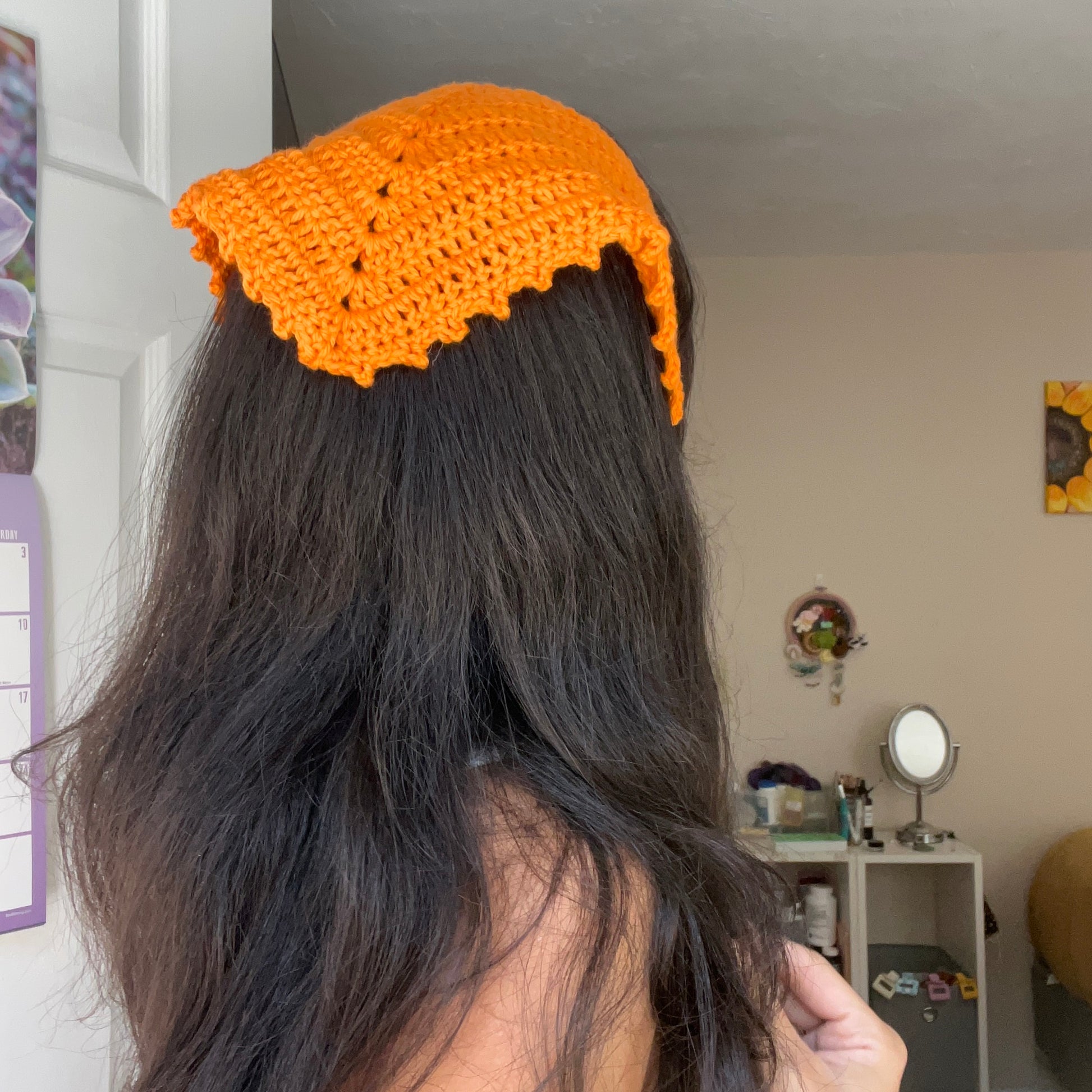 girl wearing an orange crochet hair bandana
