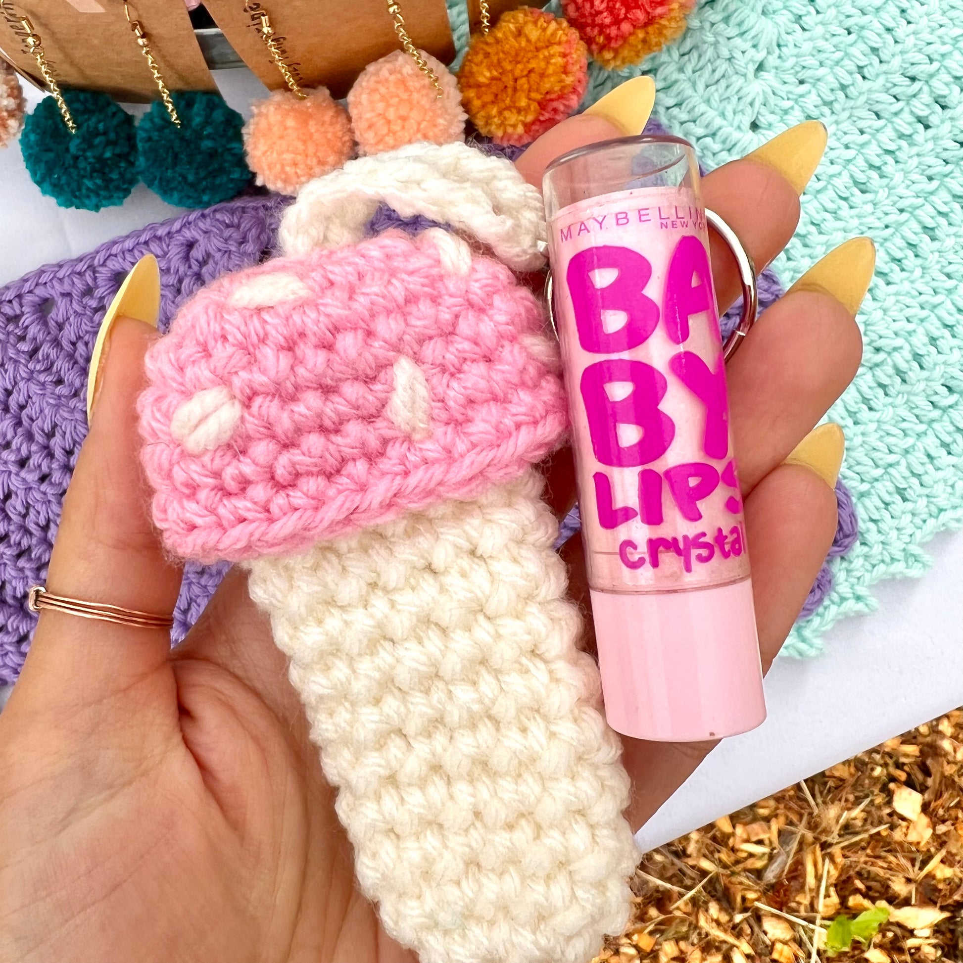 pink and white mushroom keychain that can hold chapstick