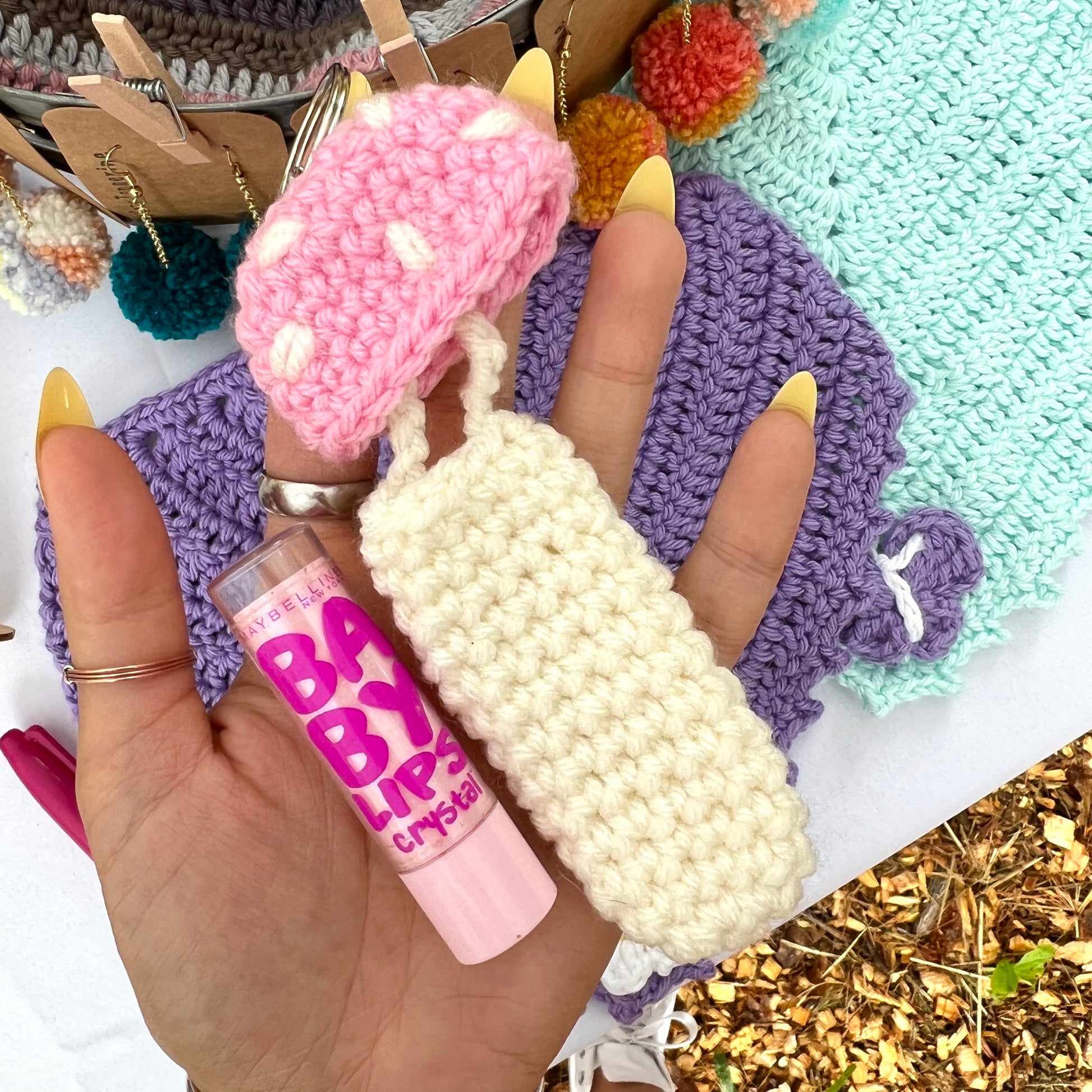 pink and white crochet mushroom keychain that can hold chapstick